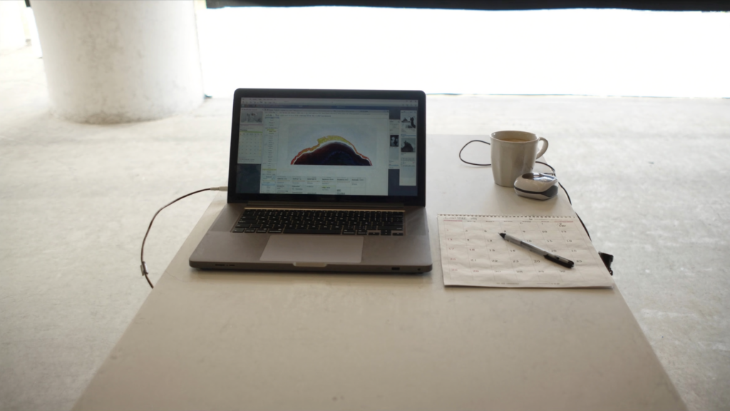 Desk with a laptop and a calendar, representing dental appointment scheduling software