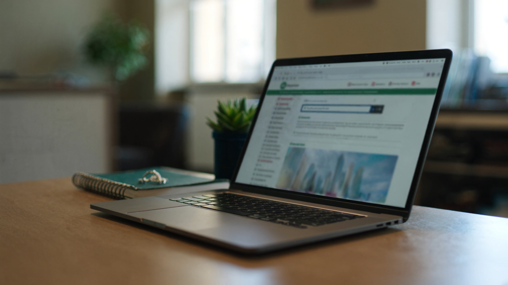 Laptop showing a website on a desk, representing converting dental website visitors into patients