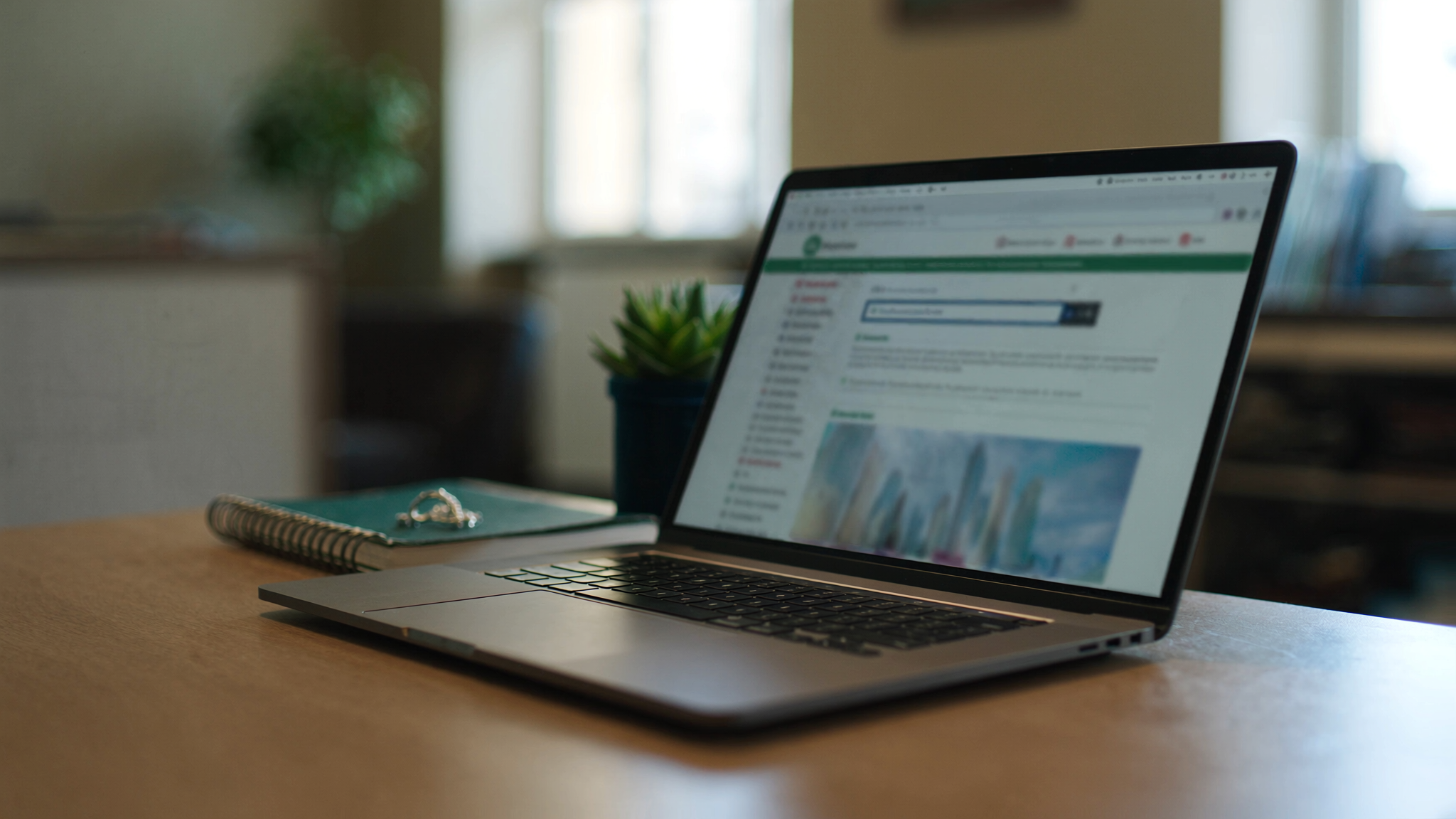 Laptop showing a website on a desk, representing converting dental website visitors into patients