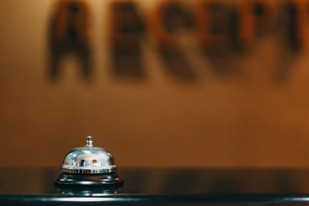 A silver call bell on a reception counter.